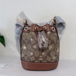 Coach Dempsey Drawstring Bucket Bag 15 In Signature Canvas With Snowflake Print.